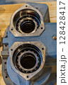 Close up of two roller bearings inside industrial gearbox housing 128428417