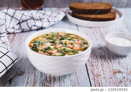 Traditional cold vegetable soup with kvass in a bowl on the table 128428592