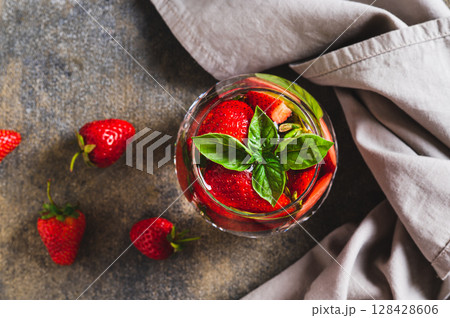Close up of summer detox water with strawberries and basil in glasses top view 128428606