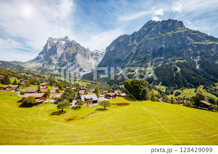 Impressive view of alpine Eiger village. Popular tourist attraction. Location place Swiss alps, Grindelwald valley, Europe. Impressive view of alpine Eiger village. Popular tourist attraction. Location place Swiss alps, Grindelwald valley, Europe. 128429099
