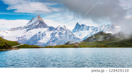 Great view of Mt. Schreckhorn and Wetterhorn above Bachalpsee lake. Location Swiss alp, Bernese Oberland, Grindelwald, Europe. Great view of Mt. Schreckhorn and Wetterhorn above Bachalpsee lake. Location Swiss alp, Bernese Oberland, Grindelwald, Europe. 128429110