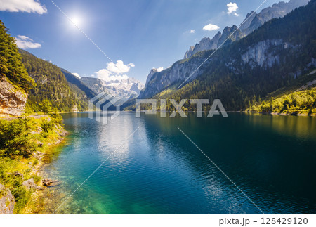 Alpine lake Vorderer Gosausee. Salzkammergut is a famous resort area located in the Gosau Valley in Upper Austria. Dachstein glacier. Alpine lake Vorderer Gosausee. Salzkammergut is a famous resort area located in the Gosau Valley in Upper Austria. Dachstein glacier. 128429120