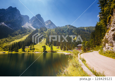 Alpine lake Vorderer Gosausee. Salzkammergut is a famous resort area located in the Gosau Valley in Upper Austria. Dachstein glacier. Alpine lake Vorderer Gosausee. Salzkammergut is a famous resort area located in the Gosau Valley in Upper Austria. Dachstein glacier. 128429121