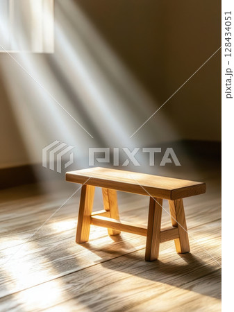 wooden bench illuminated by soft morning light in serene room creates peaceful atmosphere. gentle rays enhance natural beauty of wood 128434051