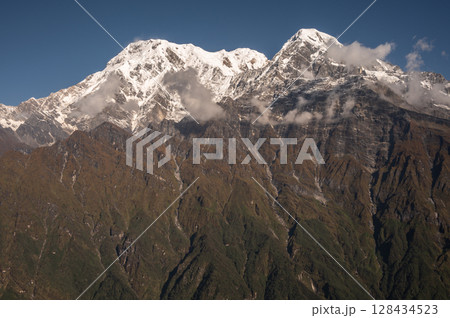 View of Mt.Annapurna South (7,219 m) and Mt.Hiunchuli (6,441 m) seen from Mardi Himal view point in the Annapurna region of Nepal.  View of Mt.Annapurna South (7,219 m) and Mt.Hiunchuli (6,441 m) seen from Mardi Himal view point in the Annapurna region of Nepal.  128434523