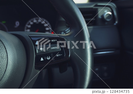interior view of car with black leather, steering wheel with button interior view of car with black leather, steering wheel with button 128434735