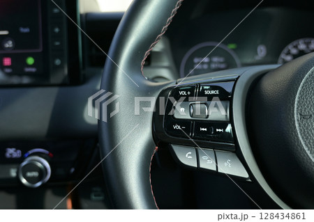 interior view of car with black leather, steering wheel with button interior view of car with black leather, steering wheel with button 128434861