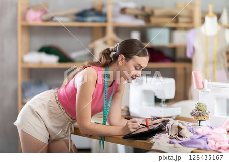Woman designer use stylus to draw on graphics tablet Woman designer use stylus to draw on graphics tablet 128435167