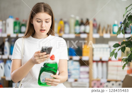 Young woman scanning qr code for dishwashing 128435483
