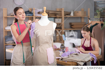 Women working in a sewing salon 128435582