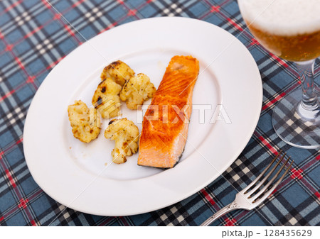 Salmon with cauliflower on a white plate 128435629