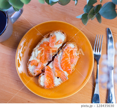 Sandwich with salmon served on platter 128435630