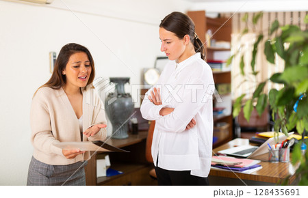 Unhappy woman chief screaming to young female manager 128435691