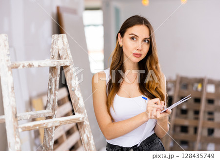 Woman construction manager checking project documentation 128435749