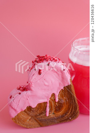 Pink drink Matcha beverage dragon fruit powder superfood Heart shaped cherry flavor croissant on pink background with copy space. Puff pastry new trendy sweet dessert bakery. Creamy dough 128436616