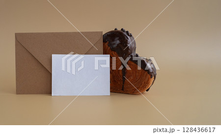 Mock up template paper note card Heart shaped dark chocolate croissant on beige background with copy space. Puff pastry new trendy sweet dessert bakery. Creamy dough 128436617