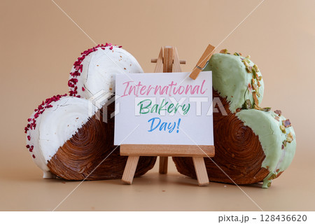 International bakery day saying caption on greeting card Delightful heartshaped pastry croissant treat, beautifully topped with colorful frosting galore. Copy space. Food experimentation viral dessert International bakery day saying caption on greeting card Delightful heartshaped pastry croissant treat, beautifully topped with colorful frosting galore. Copy space. Food experimentation viral dessert 128436620