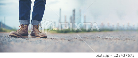 Men wear construction Boots safety footwear for worker at construction site. Engineer Wear Jeans Brown Boots Worker on Background of Refinery. Engineer safety industry fashion footwear walking outdoor 128437673