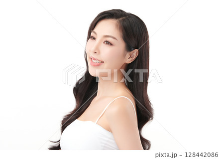 A beautiful young Asian woman with clean, fresh skin against a white background. Skincare, facial treatment, cosmetology, beauty, and spa. An elegant portrait of an Asian woman. 128442086