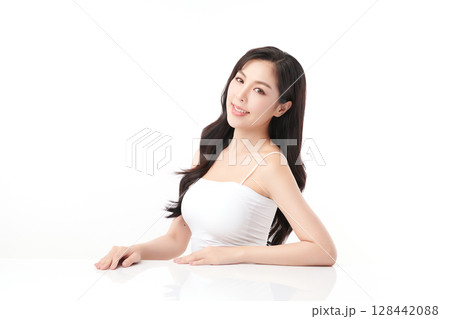 A beautiful young Asian woman with clean, fresh skin against a white background. Skincare, facial treatment, cosmetology, beauty, and spa. An elegant portrait of an Asian woman. 128442088