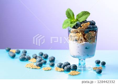 Blueberry dessert with rye flakes and fresh berries. 128442332