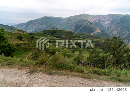 Chokhsky terraces Dagestan. Landscape of mountainous Dagestan with terraced fields and peaks mountains in the distance. Chokhsky terraces Dagestan. Landscape of mountainous Dagestan with terraced fields and peaks mountains in the distance. 128442668