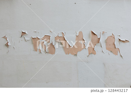 light gray concrete wall texture. Rough stone texture. Stone background. Cracked paint and plaster. 128443217