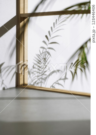 Soft sunlight through wooden windows, shadows, green leaves and texture of white walls. 128446406