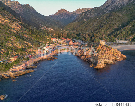Aerial view town ruins Genoese tower of Porto Corsica France medieval watchtower Mediterranean Sea Calanches de Piana 128446439