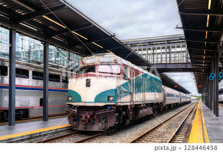 Passenger train from Portland at King Street Station in Seattle, Washington, United States, positioned under a covered platform with modern glass and metal structures 128446458