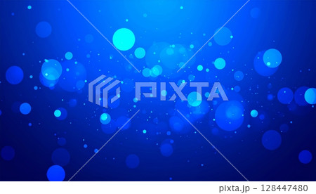 Bright blue light circles glow with a blurred, sparkling bokeh effect, creating an abstract and festive background pattern Bright blue light circles glow with a blurred, sparkling bokeh effect, creating an abstract and festive background pattern 128447480