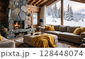 Luxury chalet living room with stone fireplace and mountain snow view 128448074