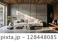 Modern minimalist living room with concrete walls and natural light streaming through large windows 128448085
