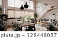 Modern open floor plan living room with dining area and natural light from large windows 128448087