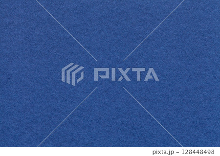 Texture of navy blue paper background with macro structure. Vintage dark denim cardboard backdrop closeup 128448498