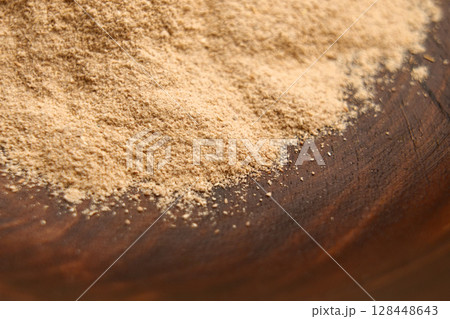 Ayurvedic Ashwagandha root powder in wooden bowl. Calming anti-stress supplement. Ayurvedic Ashwagandha root powder in wooden bowl. Calming anti-stress supplement. 128448643