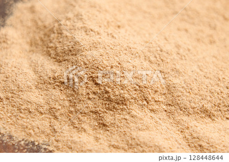 Ground Ashwagandha root powder. Dried Ayurvedic anti-stress supplement. Macro shot. Ground Ashwagandha root powder. Dried Ayurvedic anti-stress supplement. Macro shot. 128448644