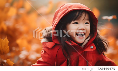Autumn Joy: Little Asian Girl Frolicking in Fall Leaves with Bright Jacket. Generative ai 128449473