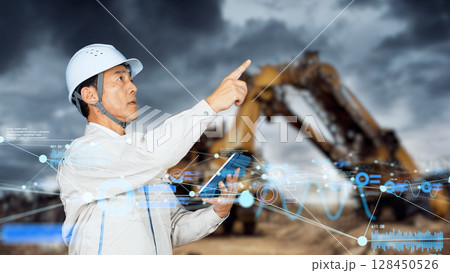 建設現場でタブレットを使うエンジニアとデジタルデータ 128450526