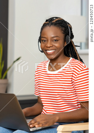 Pretty young smiling woman with a laptop looking happy Pretty young smiling woman with a laptop looking happy 128450713