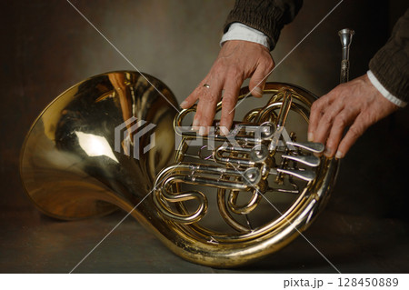 french horn an ancient musical metal instrument popular in classical brass music an instrument beloved by children and adults, amateurs and professionals 128450889