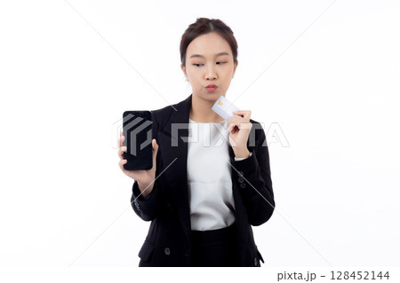 Portrait young asian businesswoman holding credit card and smartphone while thoughtful isolated. 128452144