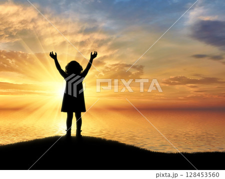 Silhouette, little happy baby girl standing on a hill near the sea on a background Silhouette, little happy baby girl standing on a hill near the sea on a background 128453560