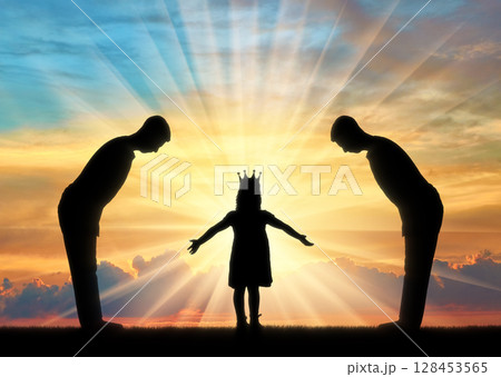 Selfish little girl with a crown on her head and two servants worship her Selfish little girl with a crown on her head and two servants worship her 128453565