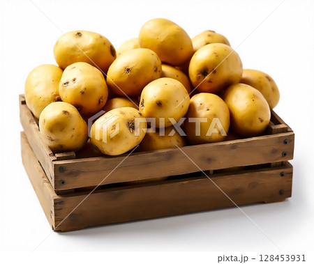 Freshly harvested yellow potatoes arranged in a wooden crate for market display 128453931