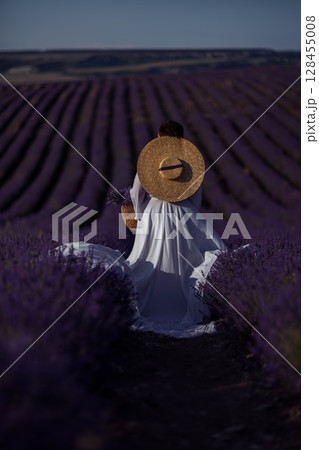 Lavender Woman Hat: Back view of person harvesting flowers in the field during daytime. 128455008