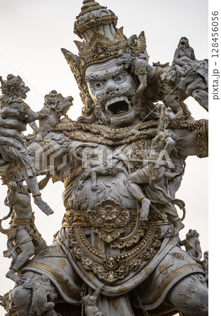Statue of God fighting with monkeys in Pura Luhur Uluwatu, Bali, Indonesia 128456056