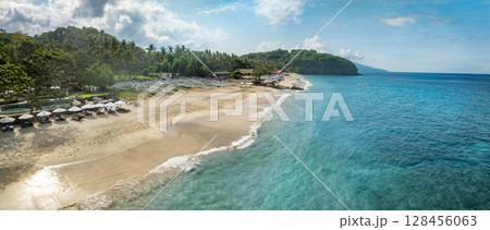 Top Aerial view of famous Virgin Beach in Bali, Indonesia. Empty paradise beach, blue sea waves in Bali island, Indonesia Top Aerial view of famous Virgin Beach in Bali, Indonesia. Empty paradise beach, blue sea waves in Bali island, Indonesia 128456063