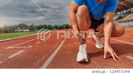 Runner Ankle Injury on Outdoor Track 128457249