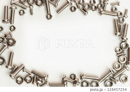 Stainless Steel Nuts and Bolts on White Background Stainless Steel Nuts and Bolts on White Background 128457254